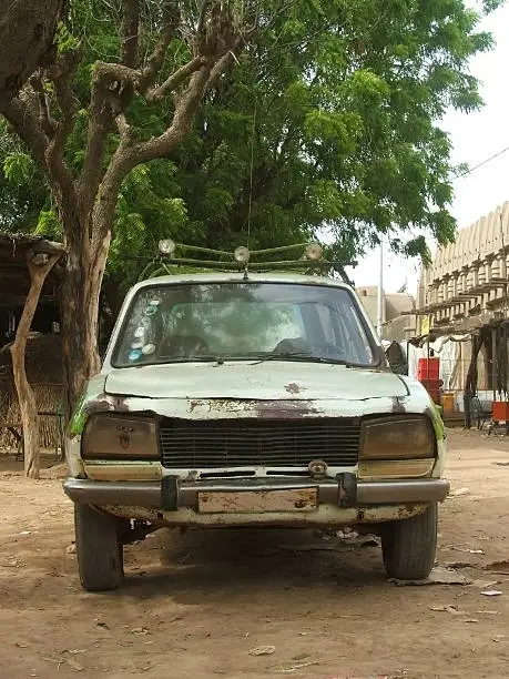 A very old Peugeot 504 in the streets of Djenne, Mali.