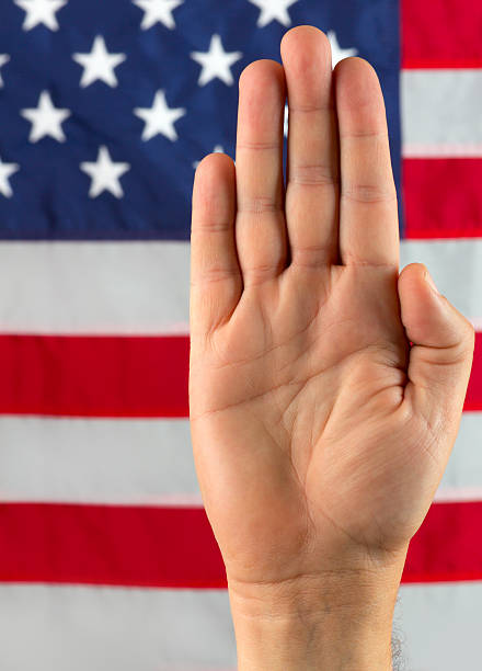 istock Pledging Hand in Front of American Flag 147777794