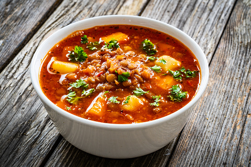 Tomato soup with chickpea on wooden background