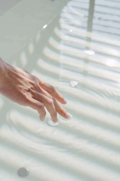 Close up hand of woman enjoy take a bath in hot tub stock photo