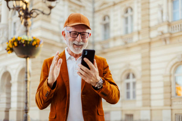 istock Elderly Male Watching Funny Video 1477779991