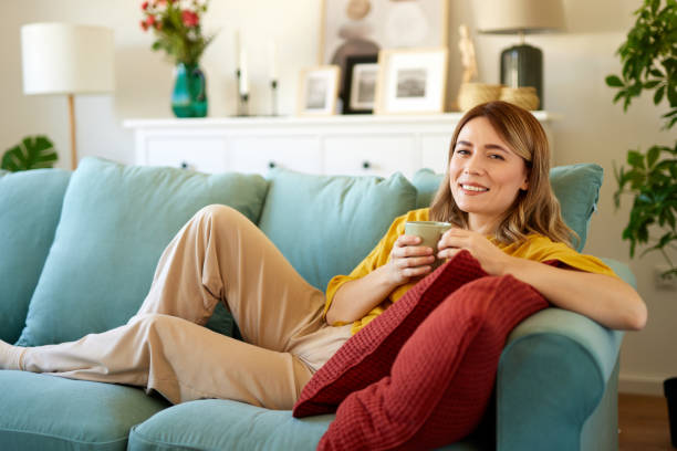 istock An attractive young woman relaxing at home drinking coffee 1477781112