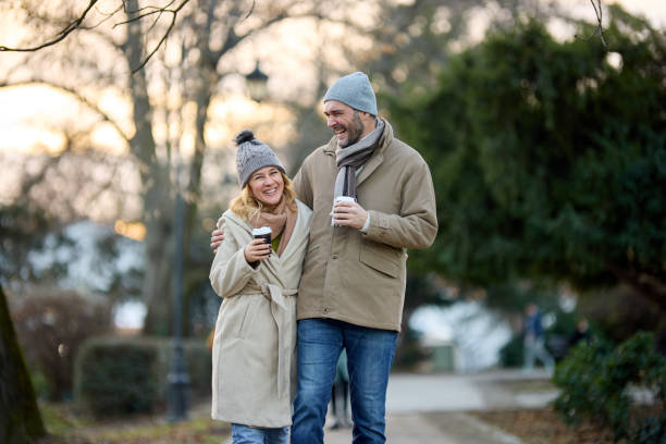 istock A happy romantic couple with coffee walking in the park 1477781752