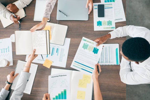 istock Collaboration, documents and financial with a business team working together in an accounting office from above. Meeting, data and finance planning with a man and woman accountant group at work 1477783971