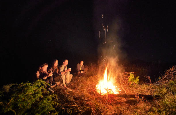 istock Young family drinking tea next to fire place. 1477784110