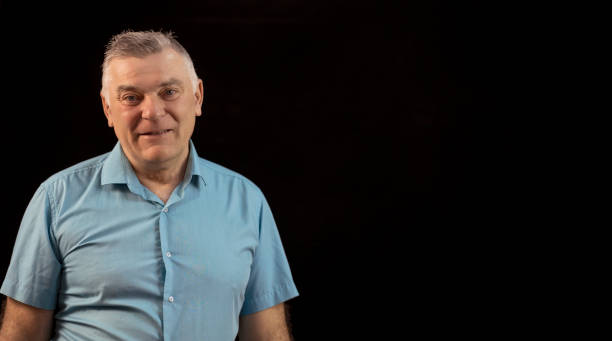 istock Mature man close up portrait, on black background. 1477784900