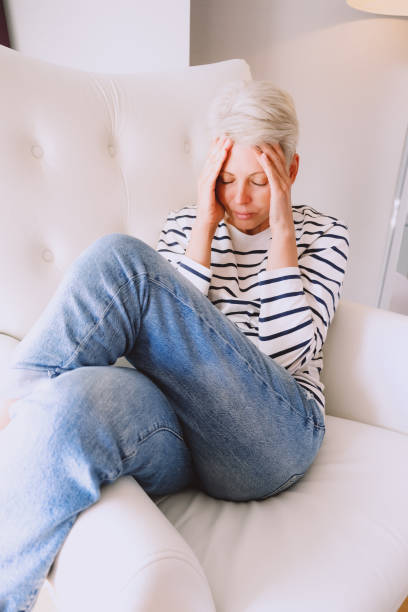 istock Middle age blonde woman having mental health issue. 1477785103