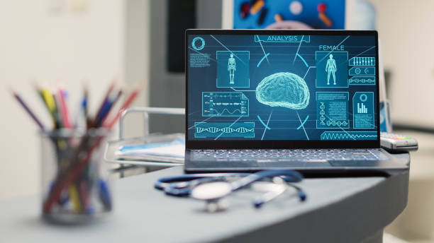 istock Laptop with human brain scan on desk 1477788303