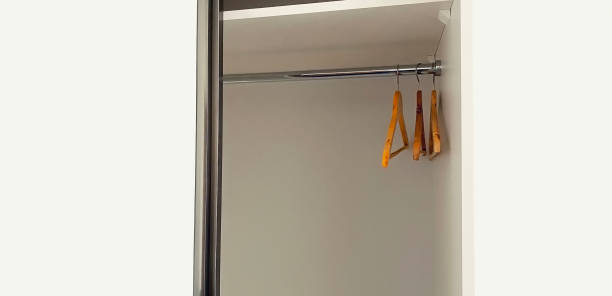 istock White empty wardrobe closet with hangers in the room 1477793101
