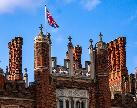 The union flag flying on top of the building with many tall columns, Hampton Court, England.