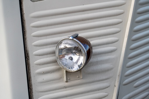 Durbach, Germany – December 25, 2022: The headlight of an old Citroen H-type corrugated iron panel van