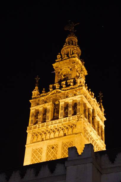 Illuminated La Giralda tower at night. Seville, Spain.