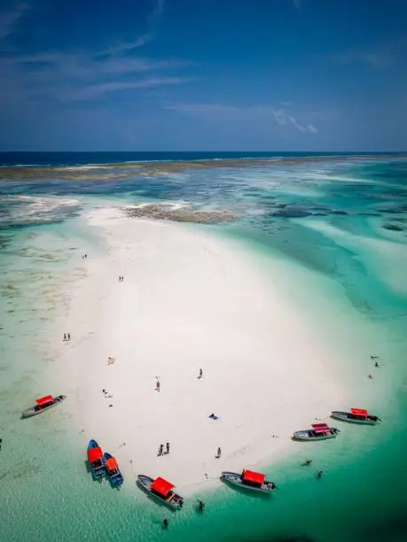 An aerial view of a picturesque tropical island, complete with white-sand beaches and crystal-clear waters