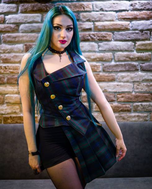 istock Young woman with an edgy look posing against  a brick wall 1477797038