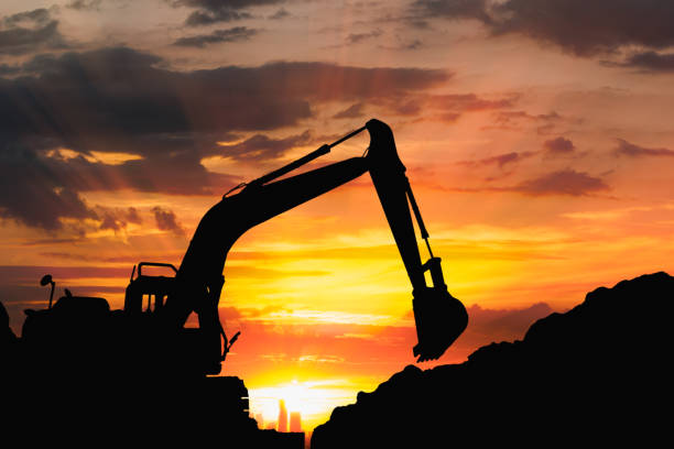 istock Silhouette of excavator loader  in the construction site . 1477798027