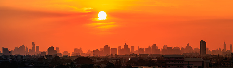 Panorama, Orange  sky and sun, At city scenery of Bangkok with Modern building silhouette (Thailand)