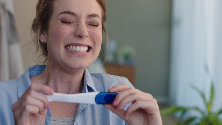 portrait beautiful woman looking at pregnancy test enjoying surprise result showing positive excited for motherhood