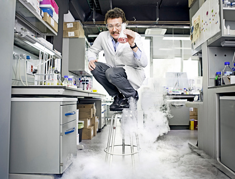 Scientist standing on chair after an explotion