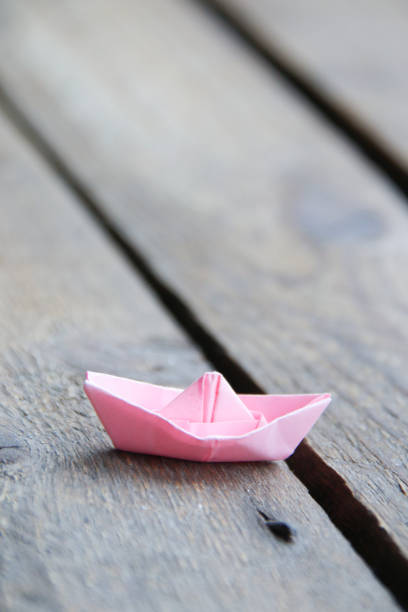 Leadership concept. Paper boat on vintage table. Summer holiday concept. stock photo