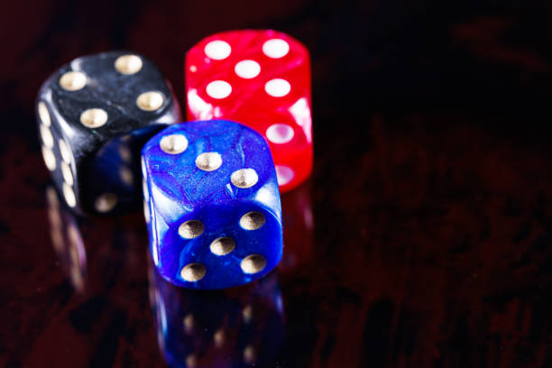 Three white dice isolated on a white background.  Photo has a shallow DOF.  Includes a clipping path.