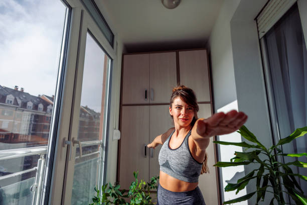 istock Woman doing yoga session at home 1477804385