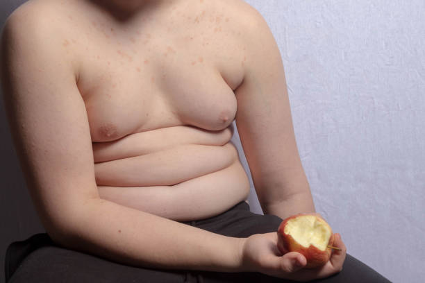 istock An overweight teenage boy with an apple 1477806557