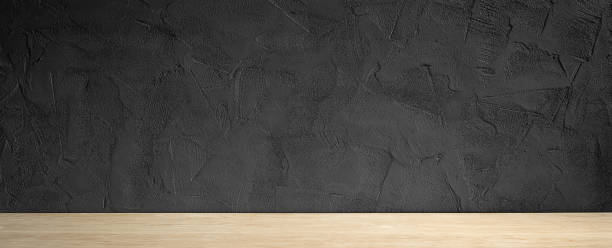 istock A light wood table top with a black stone wall. Product presentation background 1477806577