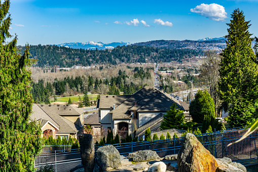 A landscape scene with builtding, tree and mountains in Issaquah, Washington.