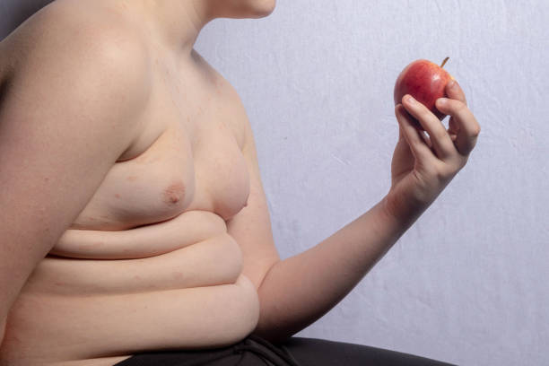 istock An overweight teenage boy with an apple 1477808005