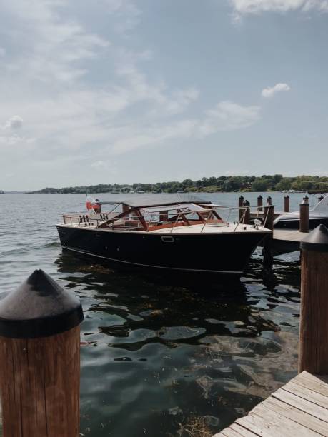 istock Wooden dock with a boat tied to it 1477810411