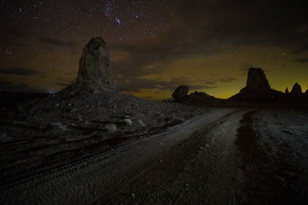 istock Tranquil night scene in the desert featuring an illuminated road stretching out into the horizon 1477811311
