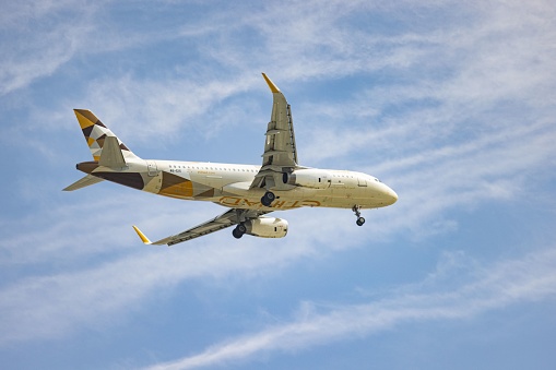 Abu Dhabi, United Arab Emirates – March 08, 2023: A commercial airliner taking off from an airport against a backdrop of a clear blue sky