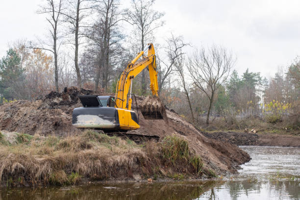 istock Big excavator digging artificial pond in countryside 1477812350