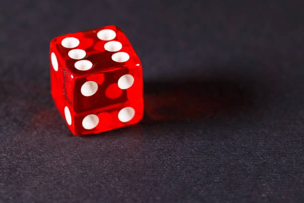 Close-Up Of Red Dices On Green Table