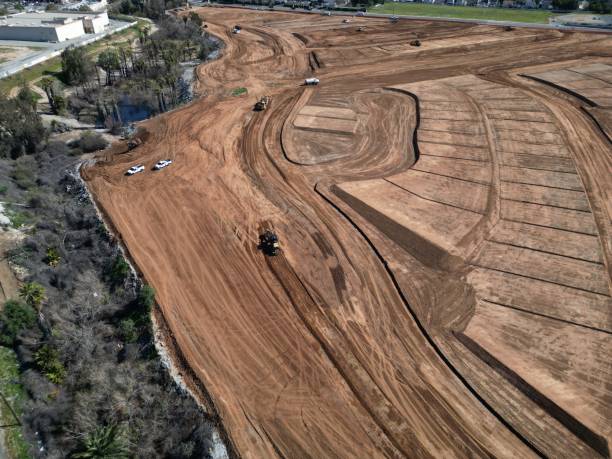 istock a construction area with a bunch of trucks in the dirt 1477814228