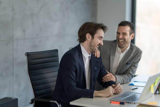 istock Two cheerful businessmen laughing in the office. 1477814891