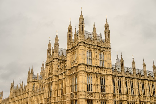 An exterior view of the House of Parliament in London, England, showcasing its grandiose gothic architecture