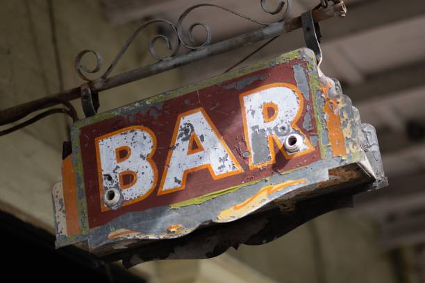 istock Distressed, rusty metal pole displays a faded sign that reads 'bar'. 1477815340
