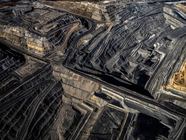 istock a massive dirt pit with lots of coal on it and two other smaller piles 1477815522