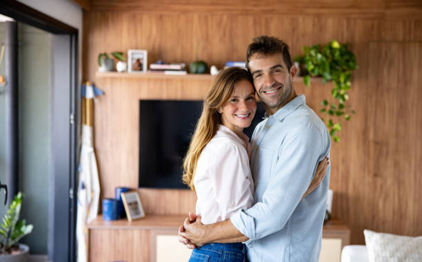 istock Loving couple smiling at home 1477815957
