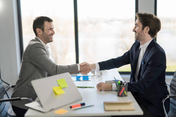 istock Businessmen shaking hands in the office. 1477816762