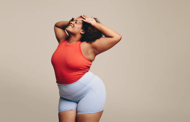 istock Expressive dance workout: Curvy woman enjoying moving her body 1477817634