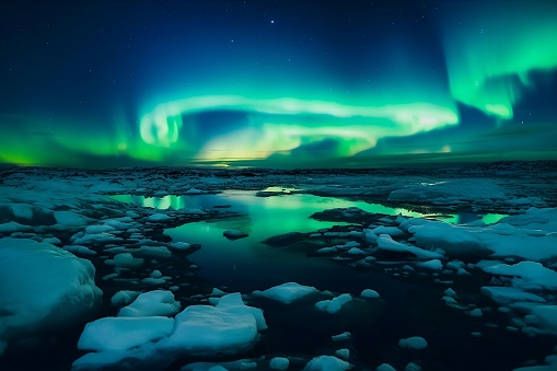 A vibrant aurora borealis lights up the night sky, illuminating the icy landscape of frozen floes below