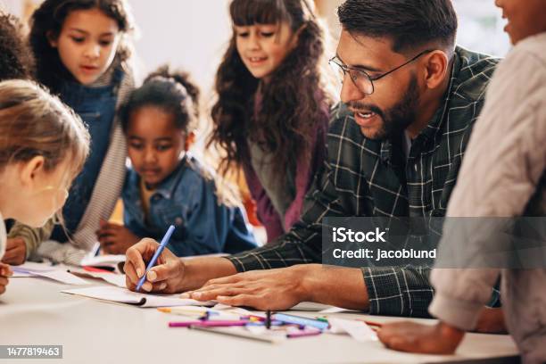 Man Teaches His Students How To Draw In A Primary School Class Stock Photo - Download Image Now