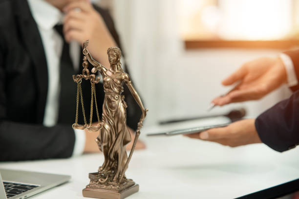 istock Lawyer sitting with team at office 1477820624