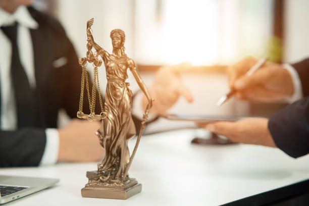 istock Lawyer sitting with team at office 1477820936