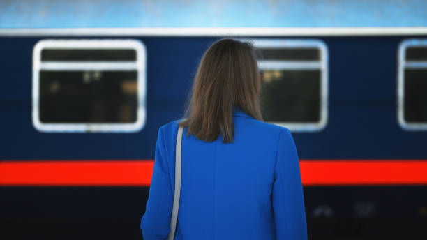 istock Woman looks at a train passing by. 1477821176