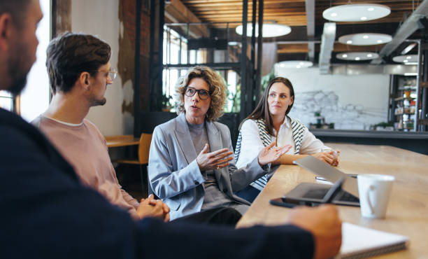 istock Business people having a discussion over a project in an office 1477822368