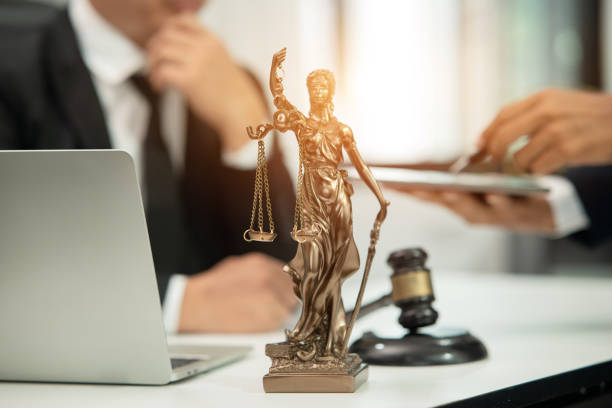 istock Lawyer sitting with team at office 1477823808