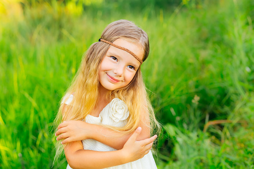 Smiling young girl with purple flowers in her hair